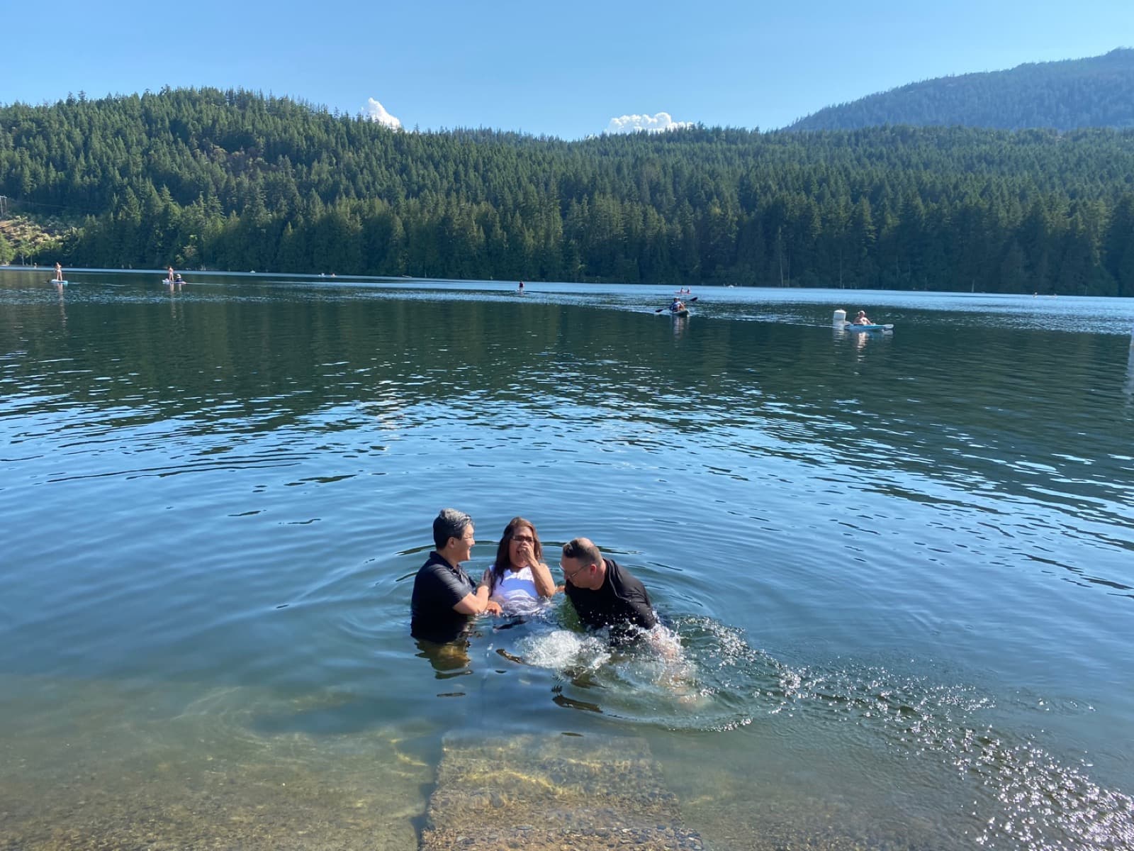 A shared moment of baptism in the water.