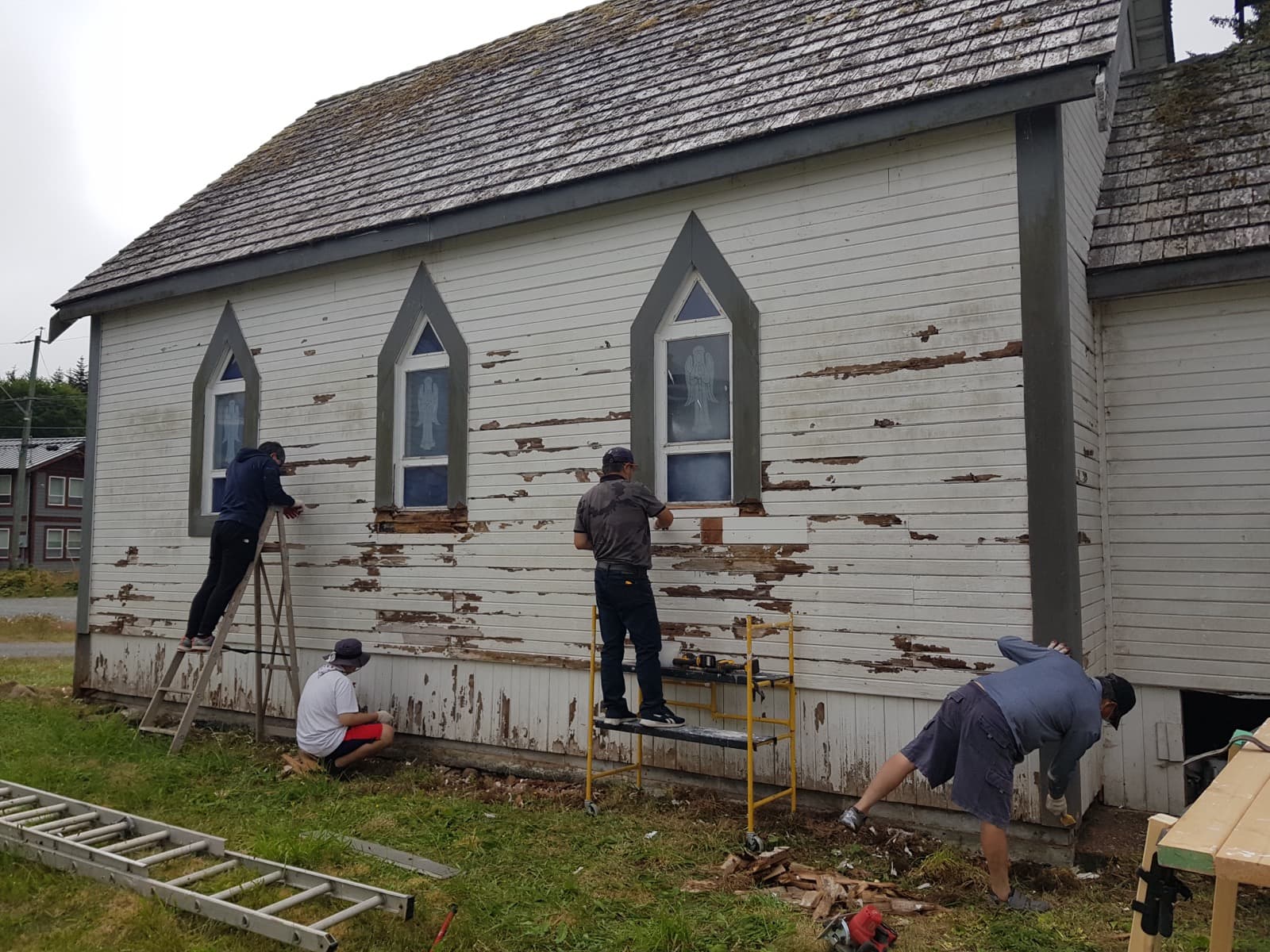 Rebuilding Fort Rupert Church — restoring the old siding together.